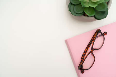 Office Supplies Over Desk With Keyboard And Glasses And Coffee Cup For Working Remotely, Assorted School Utilities For Studying With Hot Drink And Eyeglasses.の写真素材