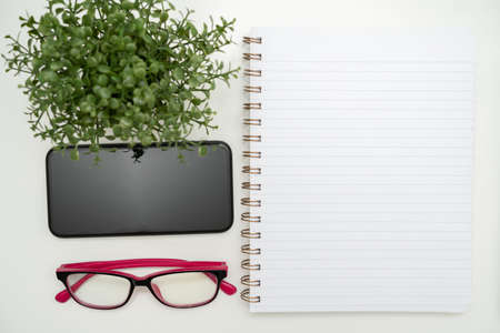 Office Supplies Over Desk With Keyboard And Glasses And Coffee Cup For Working Remotely, Assorted School Utilities For Studying With Hot Drink And Eyeglasses.の写真素材