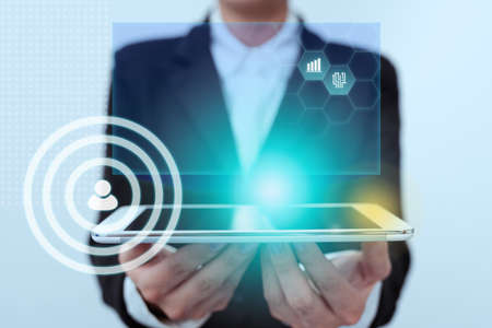 Lady In Uniform Standing Holding Touchpad With Two Hands Showing Futuristic Interface. Woman In Suit Carrying Tablet Displaying Modern Virtual Technology.の写真素材