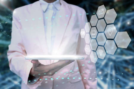 Lady In Uniform Standing Holding Tablet In Hand Presenting Virtual Modern Technology. Business Woman Carrying Tab Pointing For New Futuristic Tech.の写真素材