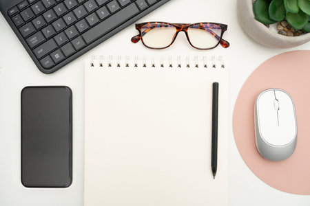 Office Supplies Over Desk With Keyboard And Glasses And Coffee Cup For Working Remotely, Assorted...