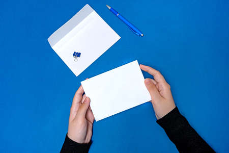 Woman Hand Holding Blank Notes Writing New Messege Updates Ideas. Lady Palm Showing Envelope Folding Sending Letters Post Address.の写真素材