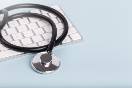 Black stethoscope and keyboard
