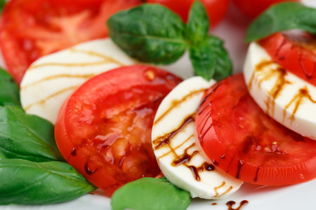 Mozzarella cheese and tomatoes balsamic dressing close up macro, caprese saladの写真素材