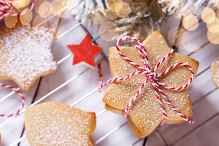 A stack of Christmas gingerbread shortbread cookies on white wooden tableの写真素材