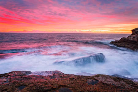 Blazing red sunrise over the Sydney east coastの写真素材