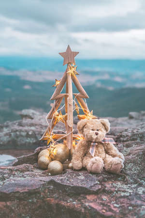 Christmas tree with golden star lights against mountain backdropの写真素材