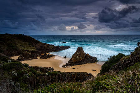 Stormy skies over coastal landscape with impressive sea stacksの写真素材