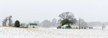 Farm house and outbuildings in the snowy landscapeの写真素材