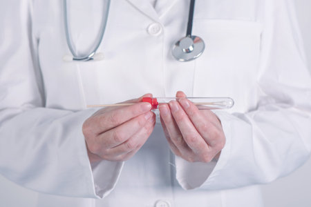 Female doctor preparing test tube for biological specimen, close up of hands