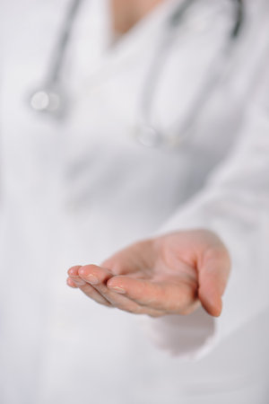 Female doctor lending hand requesting money for service, selective focusの写真素材
