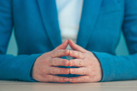 Steepled fingers of business woman as hand gesture sign of confidence, self-esteem, power and domination.の写真素材