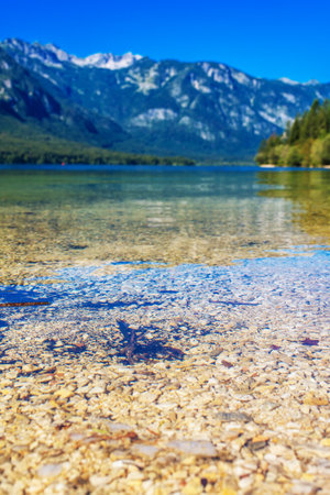 Bohinj lake in Slovenian national park Triglav with Julian Alps reflecting on surfaceの写真素材