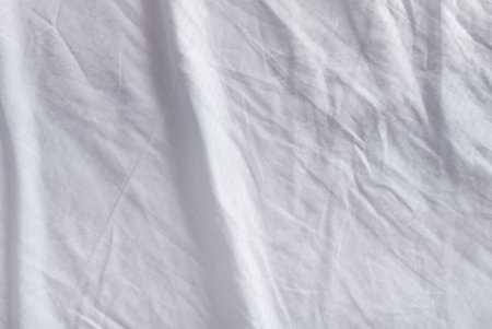 Crumpled bedding texture, top view of used bed sheetsの写真素材