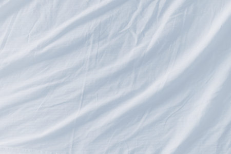 Crumpled bed sheets texture as background, top view