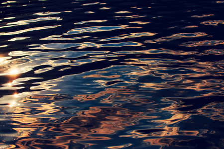 Water surface with ripples in sunset as abstract nature and environment backgroundの写真素材