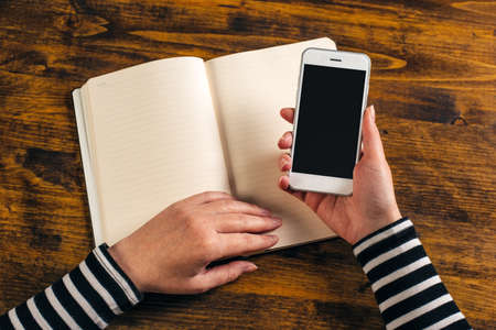 Top view mockup of female hands using smartphoneの写真素材