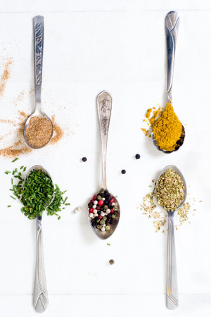 Group of spices in the spoons from above on wooden backgroundの写真素材