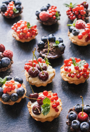 Sweet homemade tart cake with pudding and berry fruits,selective focusの写真素材
