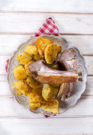 Baked lamb ribs with potatoes in the plateの写真素材