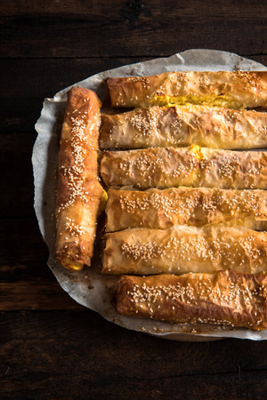 Cheese pie sticks on wooden backgroun, selective focus