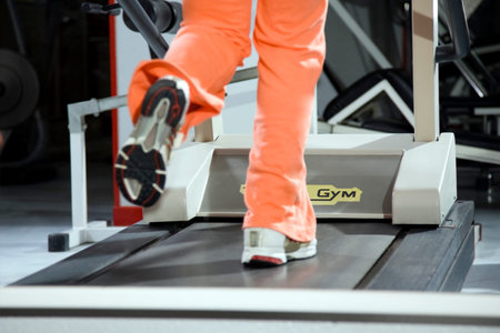 health club: woman running on a tapis roulant