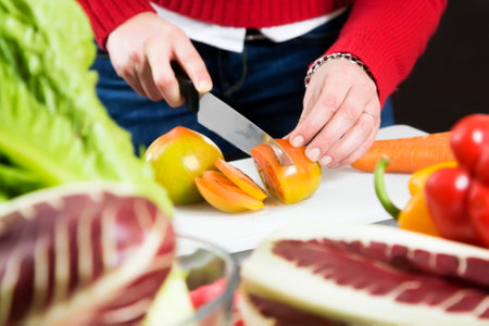 home life: woman preparing something to eatの写真素材