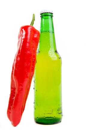 Hot chili paprika and cold bottle of beerの写真素材