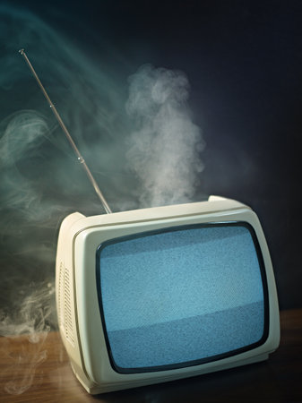 broken tv about to explode. Studio shot, vertical shape, copy spaceの写真素材