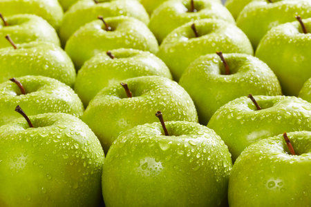 large group of granny smith apples in a row. Selective focusの写真素材