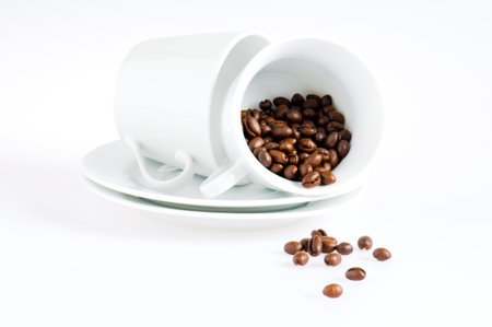 Coffee cups and coffee beans over whiteの写真素材
