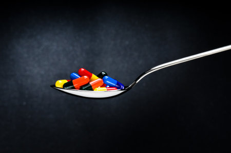 One spoon of medication in front of a grungy backgroundの写真素材