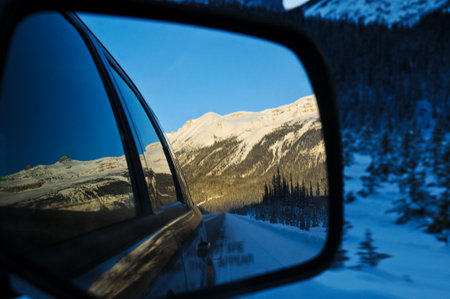 Winter landscape seen through a car mirrorの写真素材