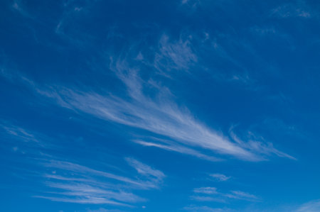 Feather clouds in a blue sky, ideal as a wallpaper or background pictureの写真素材