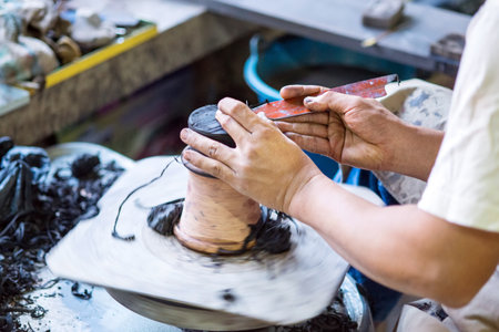 Hands working on pottery wheel of thailandの写真素材
