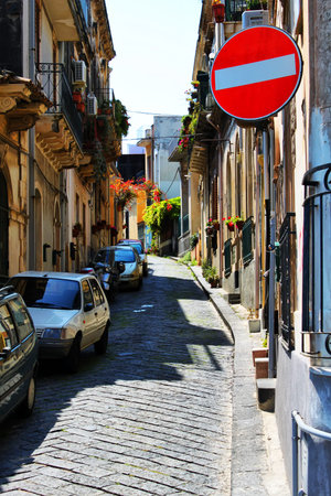 Photo of italian street, with stop roadsignの写真素材