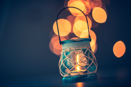 Romantic candlelight atmosphere, beautiful vintage candle lantern burning on mild blurry lights...
