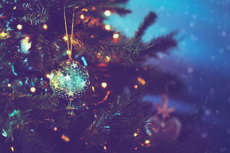 Beautiful vintage Christmas background, stylish green ball with stars on Christmas tree, festive Christmastime decorationsの写真素材