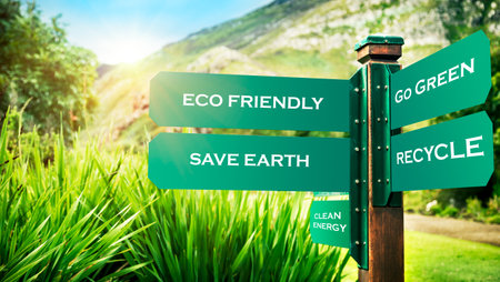 Signpost in the park with conceptual directions, eco friendly, go green, recycle and save earth, conceptual photo of ecology pollution and needs to protection natureの写真素材