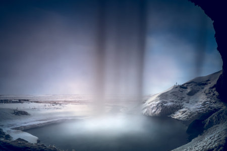 Beautiful View from inside of Seljalandsfoss Waterfall. Powerful Stream of the River. Amazing Winter...