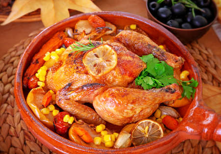 Closeup photo of tasty baked turkey in centerpiece of festive table, traditional food for Thanksgiving day holidayの写真素材