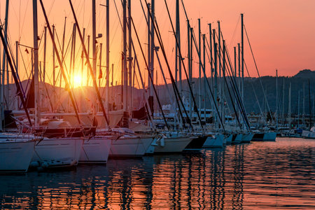 Sailboats in the harbor in mild sunset light, beautiful view on the luxury water transport in the...