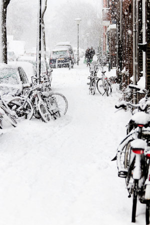 Snow in the city - streetview with bikes during snowstorm - verticalの写真素材