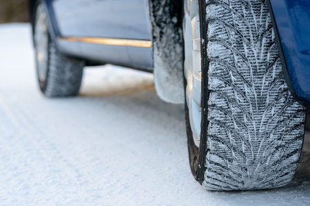Close-up Image of Winter Car Tire on the Snowy Road. Drive Safe Concept.の写真素材
