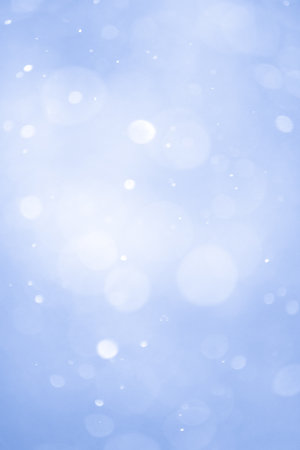 Abstract Blue Christmas Background with Real Snow. Blurred Snowflakes Photo.の写真素材