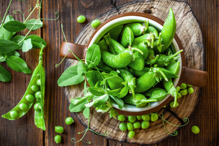 Fresh green peas on dark wooden rustic backgroundの写真素材