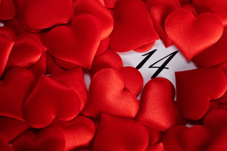 Valentine's day red silk hearts on calendar with 14 february date background, love, celebration conceptの写真素材