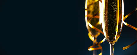 Two glasses of champagne on dark blue background New Year party celebration conceptの写真素材