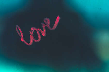 Abstract background, conceptual photo of love, passion, desire, flirt, written word on the dark vintage backdrop, romantic message for Valentines dayの写真素材