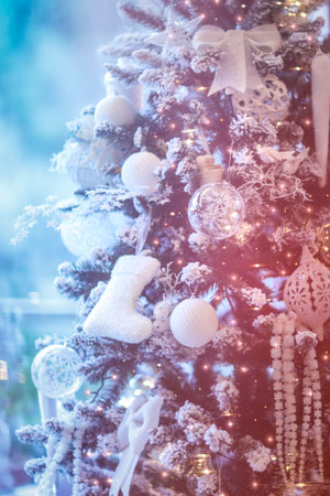 Beautiful Christmas tree, abstract dreamy festive background, pine tree decorated with stylish white baubles in magical night light..の写真素材